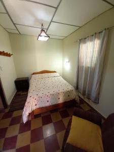 圣萨尔瓦多德朱La Primavera的一间卧室配有一张床,铺有一个 ⁇ 板地板