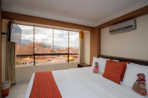 库斯科普林西比三世酒店的一间卧室设有一张床和一个大窗户