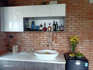 顺化Homestay Mộc Nhi的厨房设有水槽和砖墙