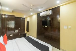 MājraCapital O Hotel Rudraksh的一间酒店客房,配有一张床和一台电视
