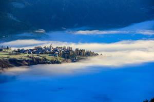 维皮泰诺顿内尔瓦尔德勒酒店的云层云的山丘上,有一座小镇的一大片水体