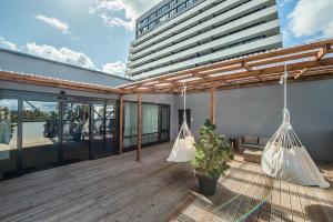 考纳斯Zaliakalnio terasos apartamentai的阳台,在大楼内配有2张吊床