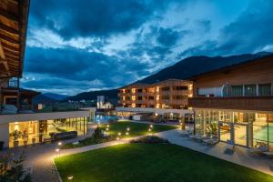 瓦莱迪卡谢斯Alpine Nature Hotel Stoll的晚上可欣赏到酒店庭院的景色