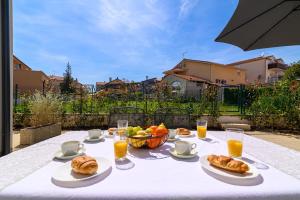 罗维尼Villa Ida的餐桌,餐饭,一碗水果和橙汁