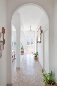 蓬扎~ ~ Brezza Mediterranea ~ ~的带有拱门的走廊,位于一个白色墙壁的房子里