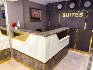 伯萨Bursa Suites Apart Otel的酒店大堂设有墙上的带时钟的柜台