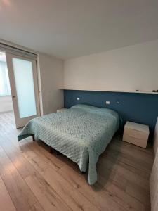 格拉多Nettuno的一间卧室配有一张蓝色墙壁的床