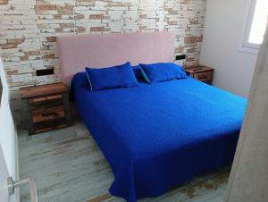 San AndrésApartamento en primera línea de mar, las Teresitas, Santa Cruz de Tenerife的卧室内的蓝色床和蓝色枕头