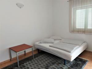 梅杜林Apartments Aurora near beach的一间小卧室,配有一张床和一张桌子