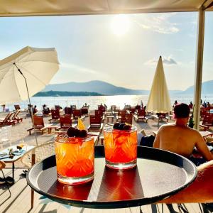 蒂瓦特Royal Blue Resort & Residences的海滩上的一张桌子和两杯鸡尾酒