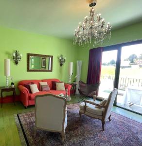 巴基奥Basarte Cottage的客厅配有红色沙发和吊灯