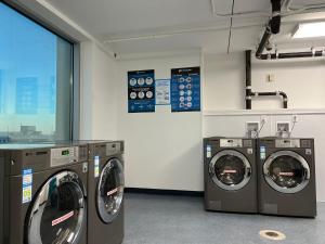 大西洋城Beachfront Double Queen - CozySuites的洗衣房配有3台洗衣机和窗户