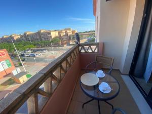 蓬塔翁布里亚Punta Umbria ideal apartamento Enebrales的市景阳台配有桌子