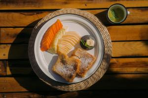 托多斯桑托斯Baja Nomads Hotel - Adults 15 Plus的桌上一盘带面包和蔬菜的食物