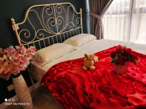 塞贝维Cozy Studio unit,Cyberjaya,Wifi, Netflix,Free parking的一只泰迪熊坐在玫瑰花覆盖的床上