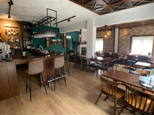 LechovoGuesthouse Monopati - Ξενώνας Μονοπάτι的一间带桌椅的餐厅和一间酒吧