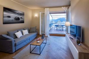 卡莫利Beautiful house with lovely sea view terrace的客厅配有蓝色的沙发和电视