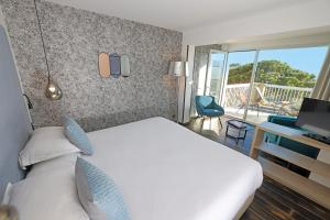 卡尔维Hotel Onda的酒店客房设有一张床和一个阳台。