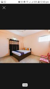 贾巴尔普尔OYO Hotel Erawat Greens的一间卧室配有一张床和一张沙发