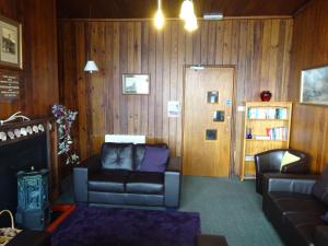 盖尔洛赫Gairloch Sands Youth Hostel的带沙发和书架的客厅