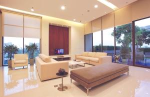 MakkasanCitiresort Living sukhumvit 39的带沙发、椅子和窗户的客厅