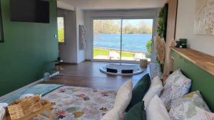 ArdresLes Secrets du Lac的带沙发的客厅,享有水景