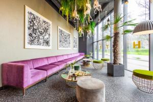弗罗茨瓦夫Hotel Zoo by Afrykarium Wroclaw - MAMY WOLNE POKOJE !的客厅配有紫色沙发和桌子