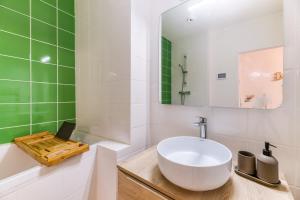 格勒诺布尔L'élégance- Centre Historique- Confort- Netflix- Marché Frais et Local的浴室设有白色水槽和绿色瓷砖