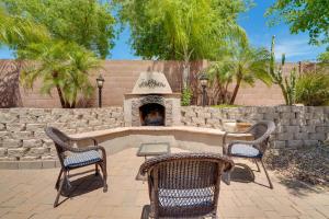 凤凰城Phoenix Vacation Home with Private Pool Near Hiking!的庭院设有壁炉、两把椅子和一张桌子