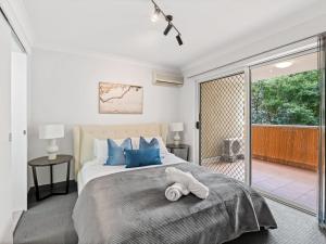 布里斯班Spacious 2 Bed 2 Bath Apartment at South Brisbane的一间卧室设有一张床和一个滑动玻璃门