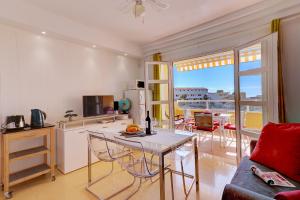 阿德耶Orlando - Sea View Apartment in Costa Adeje的一间带桌子的客厅和一间享有美景的厨房