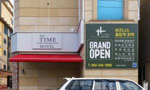 龟尾Gumi time hotel的停在大开放标志前的汽车