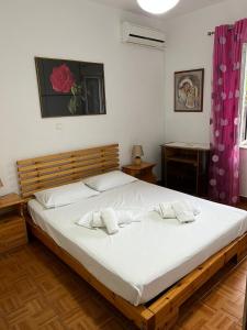 萨兰达Goni Guest House的一间卧室配有一张大床,上面有两条白色毛巾