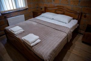 NamazaluNoravank L-and-L的一间卧室配有一张床,上面有两条毛巾