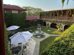 弗洛勒斯德派提酒店的庭院设有喷泉和带遮阳伞的椅子