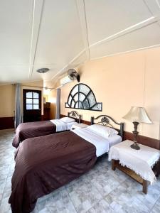 南芭堤雅NN Apartment的酒店客房,设有三张床和一盏灯
