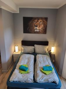弗伦斯堡Flensburg City - 24h的卧室配有一张带狮子画的床铺,墙上挂着狮子画