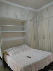 里约热内卢Quarto e Sala completo的一间小卧室,配有一张床和白色橱柜