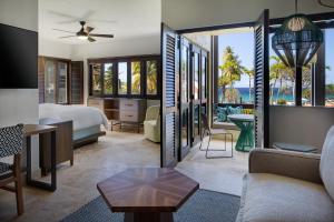 North StarCarambola Beach Resort St. Croix, US Virgin Islands的一间卧室配有一张床,客厅配有沙发