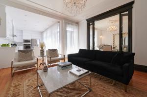 蒙特利尔Villa Dante By Denstays的客厅配有黑色沙发和桌子