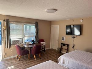 塞奎姆格瑞特豪斯汽车旅馆的酒店客房设有一张桌子和一台墙上的电视。