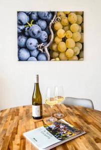 圣马丁Haus Sebald的木桌旁的一瓶葡萄酒和两杯酒