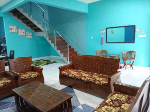 仙本那Awani homestay的客厅配有椅子和楼梯间