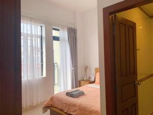 金边Ptas Tauch Residence的一间卧室设有一张床和一个窗口