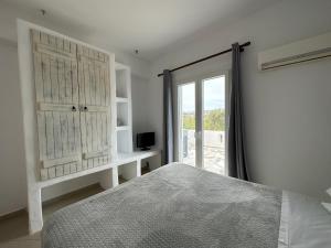 圣安娜纳克索斯Naxian Touch的白色的卧室设有床和窗户