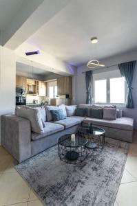 海若克利欧MegaLuxe Apartment的客厅配有沙发和2张桌子
