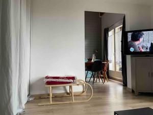 阿洛斯Appartement charmant - Allos的客厅配有椅子和电视。