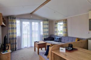 亨斯坦顿Lovely Caravan Nearby The Beach In Hunstanton, Norfolk Ref 23071c的客厅配有沙发和桌子