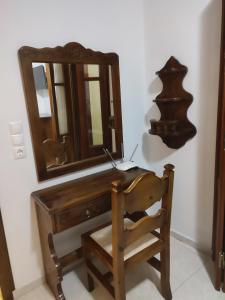 卡尔帕索斯Captain's Mermaid Houses, Karpathos的一张带椅子和镜子的木桌