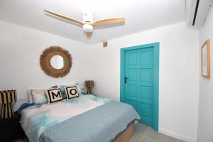 哈维亚Casa Markoli的一间卧室设有蓝色门和吊扇